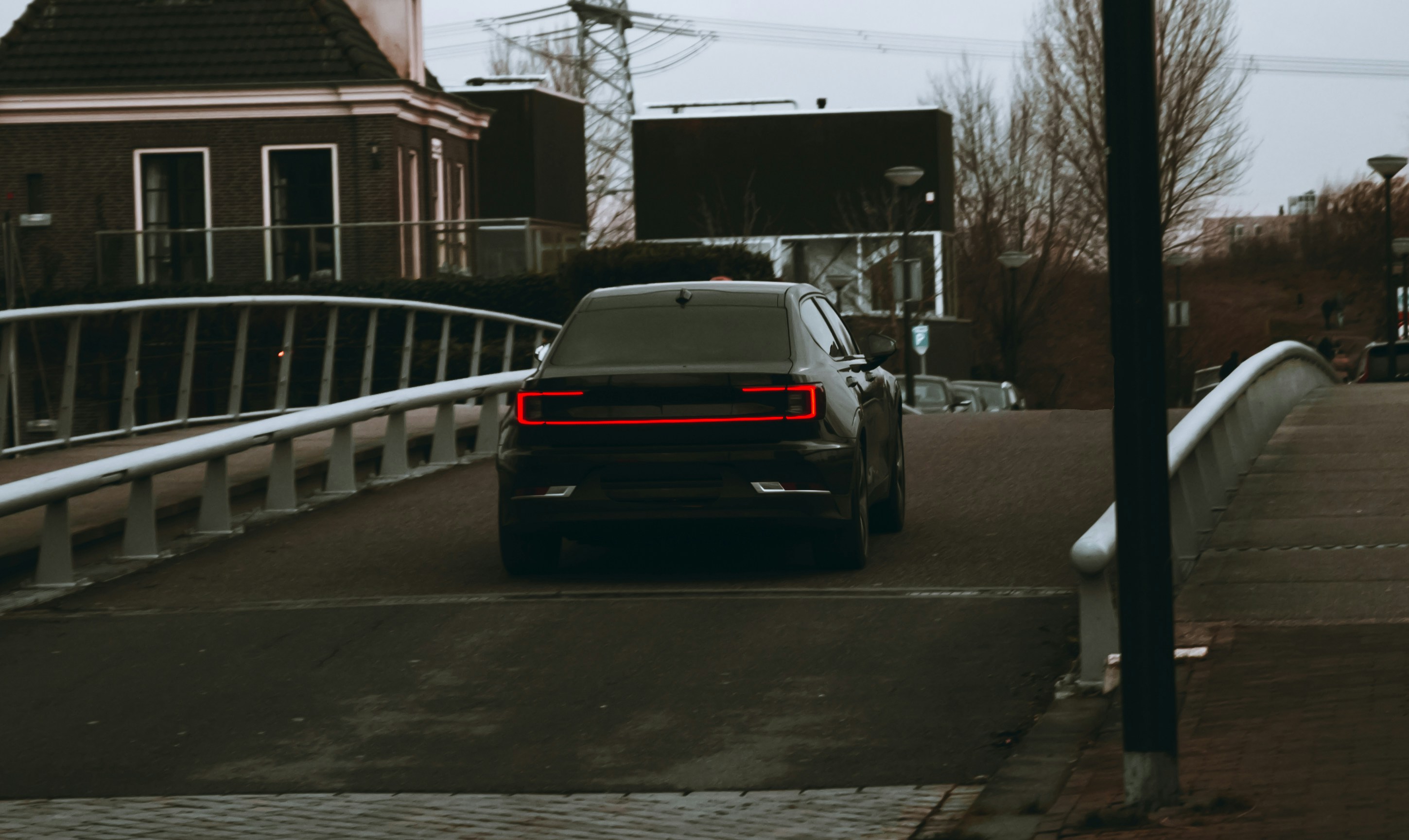 A car being driven over a bridge.