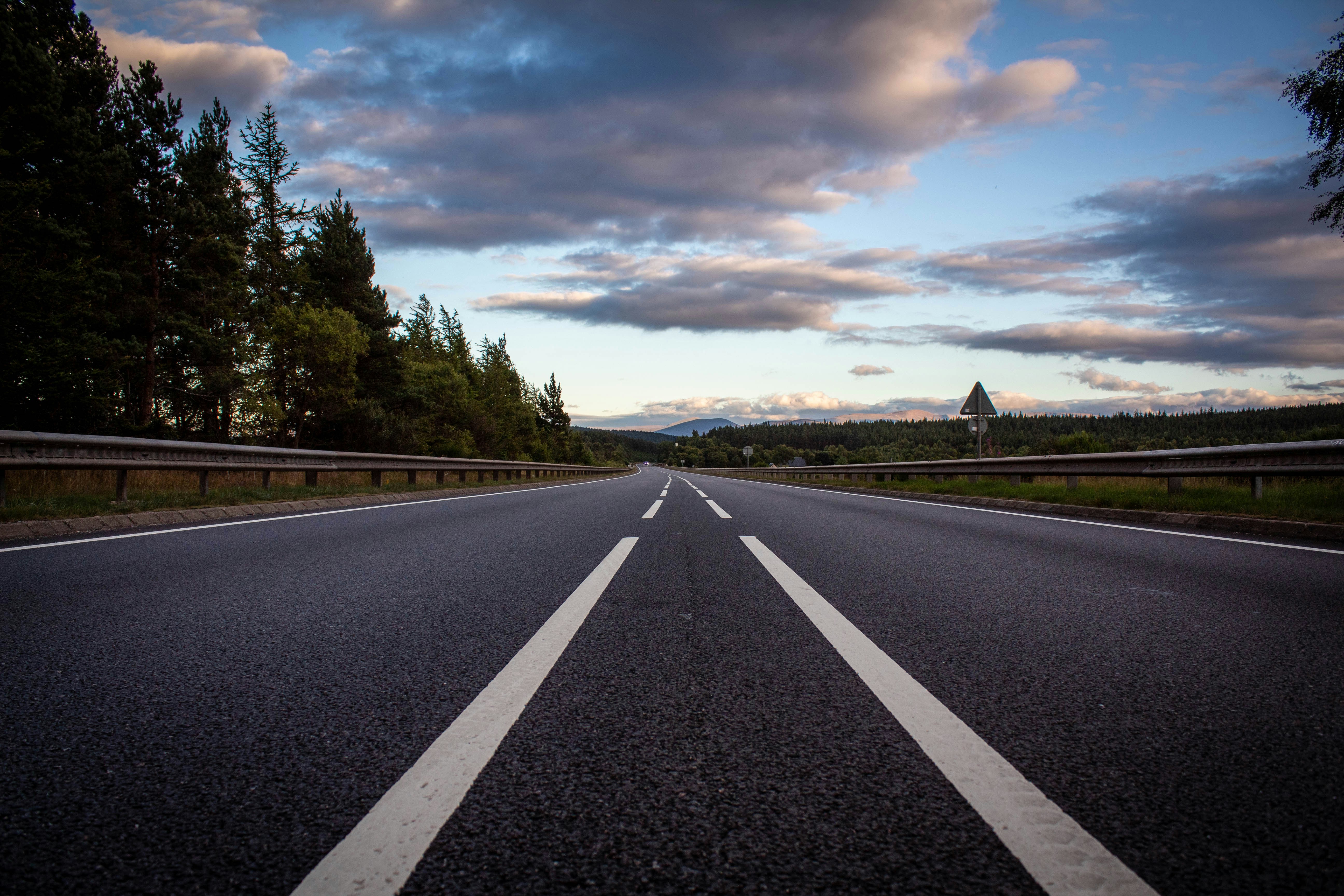 An empty road surrounded by trees.