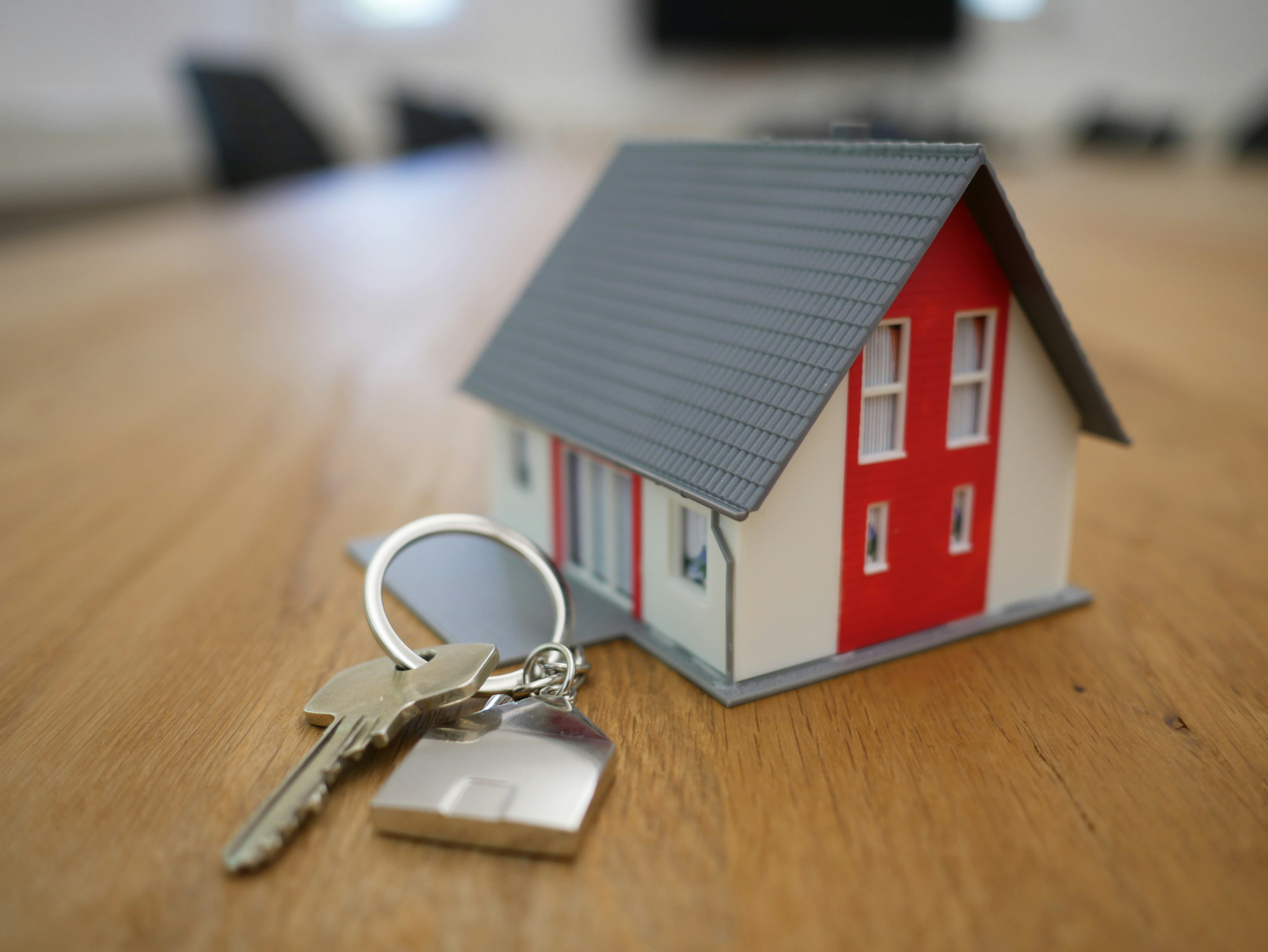 A model of a house with a set of keys.