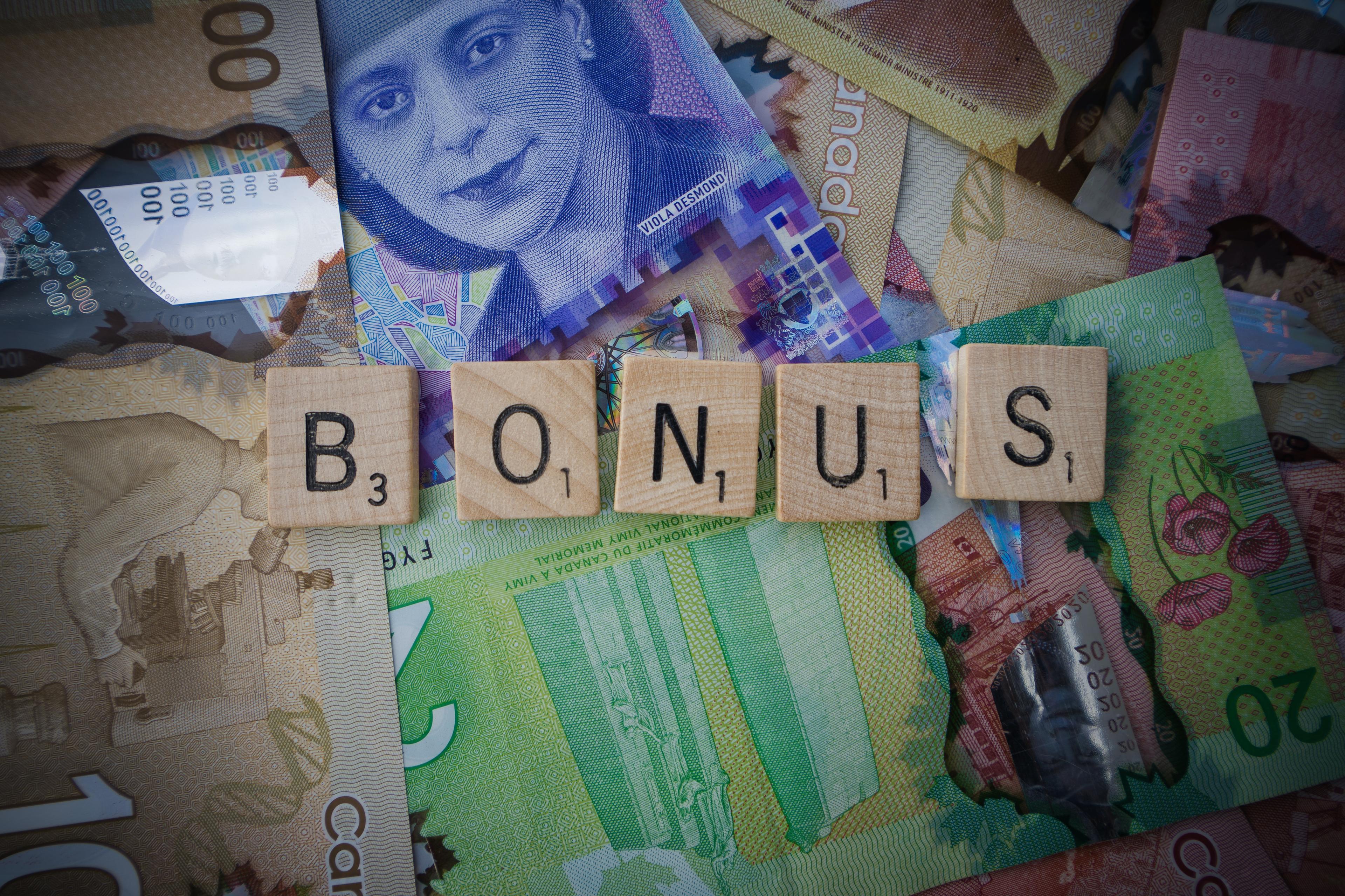 Letters spelling the word bonus on notes of money.