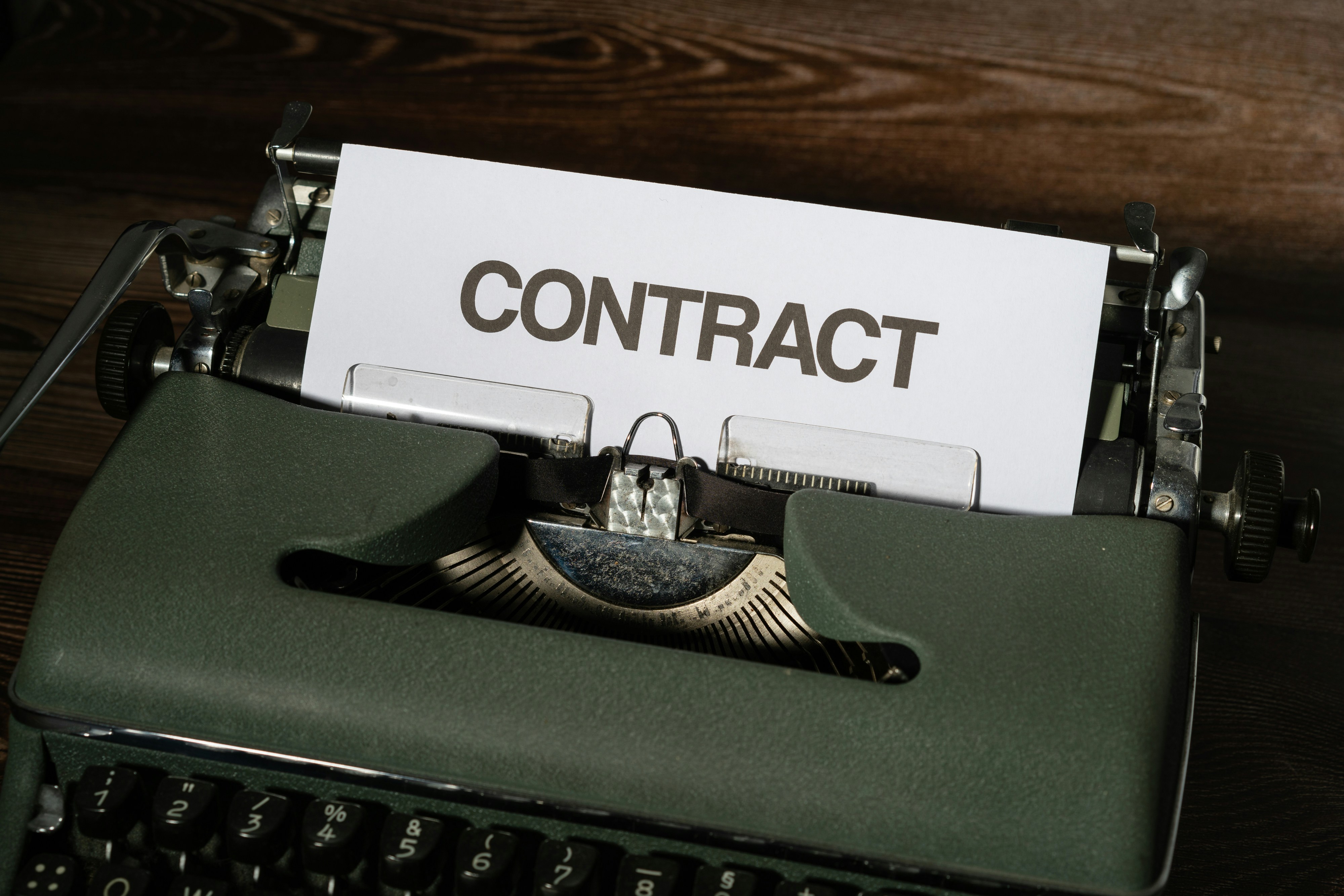 A sheet spelling 'Contract' in black letters.