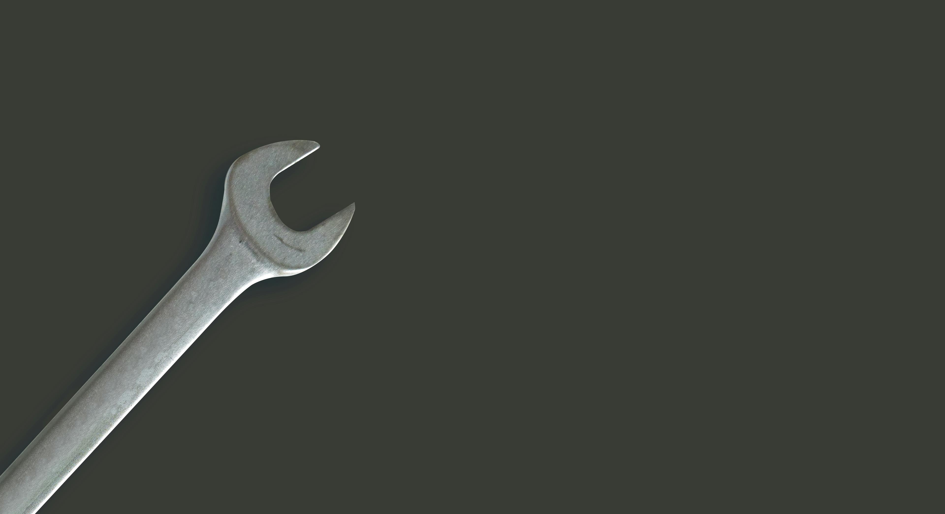 A spanner against a black background.