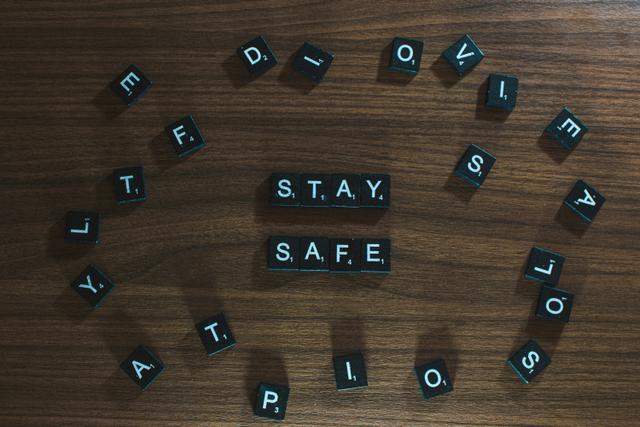 Scrabble pieces spelling the words 'stay safe'.