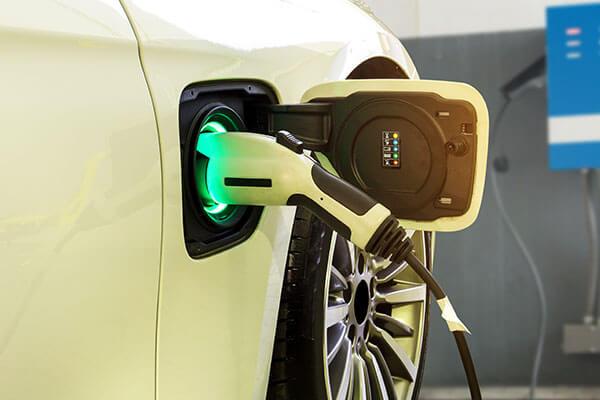 A close up of an electric car charging port